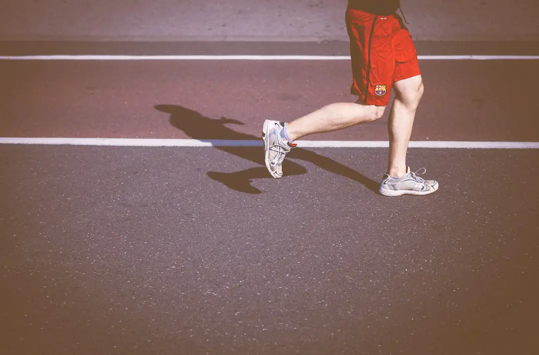 person running on concrete road