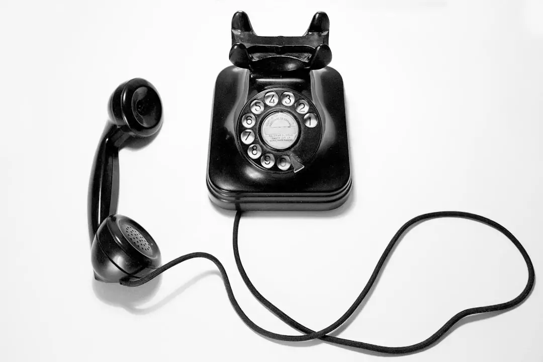 Conclusion by Walkathon Virtual black rotary dial phone on white surface