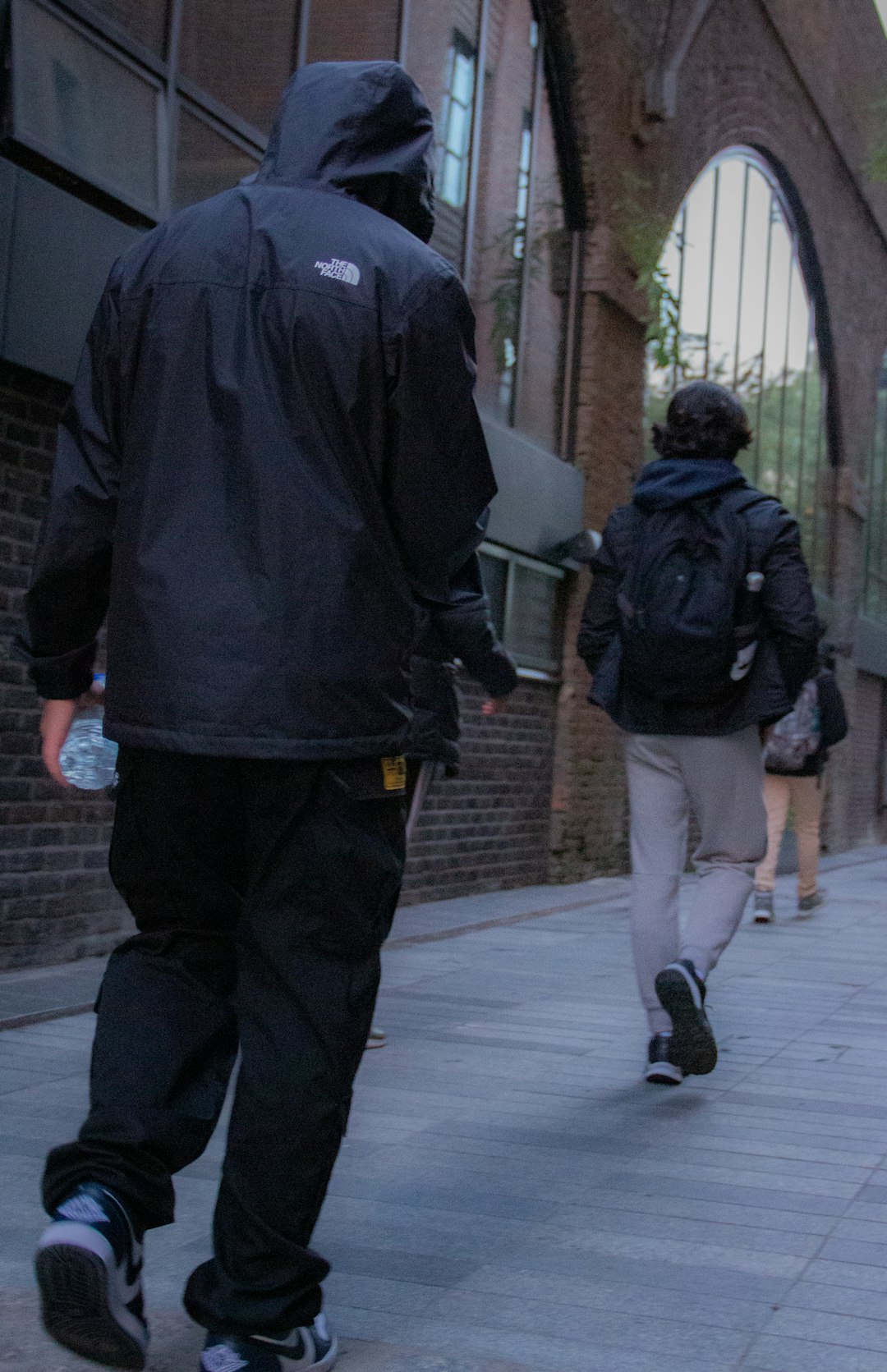 a person walking down a sidewalk