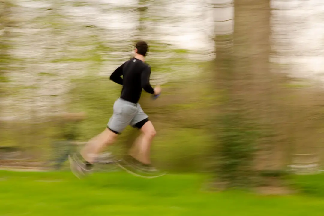 Jogging by Walkathon Virtual a blurry photo of a man running in a park